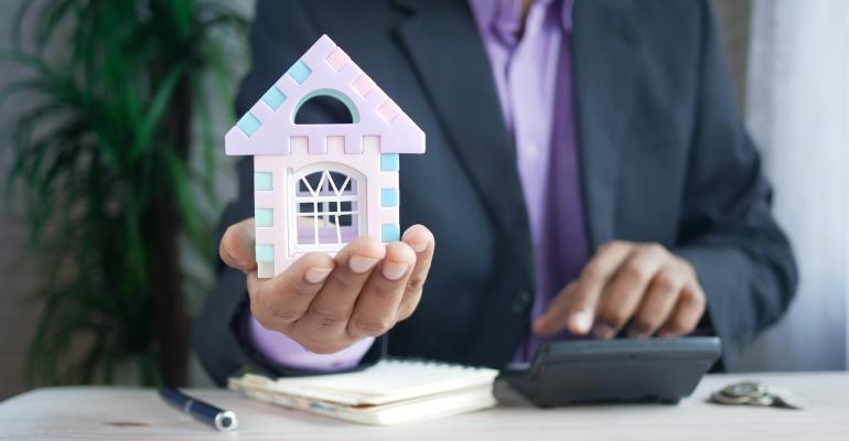 man holding house in hand property management