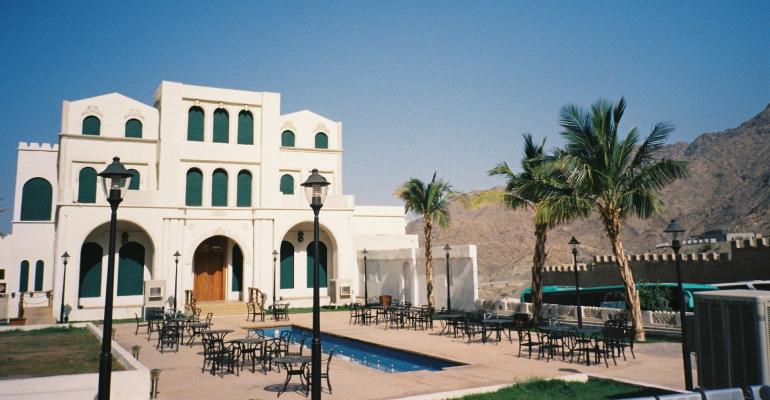 white concrete building near swimming pool during daytime in Taif Saudi Arabia