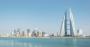 Skyline of Manama, Bahrain, dominated by Bahrain's World Trade Centre building with blue sky and still sea.jpg